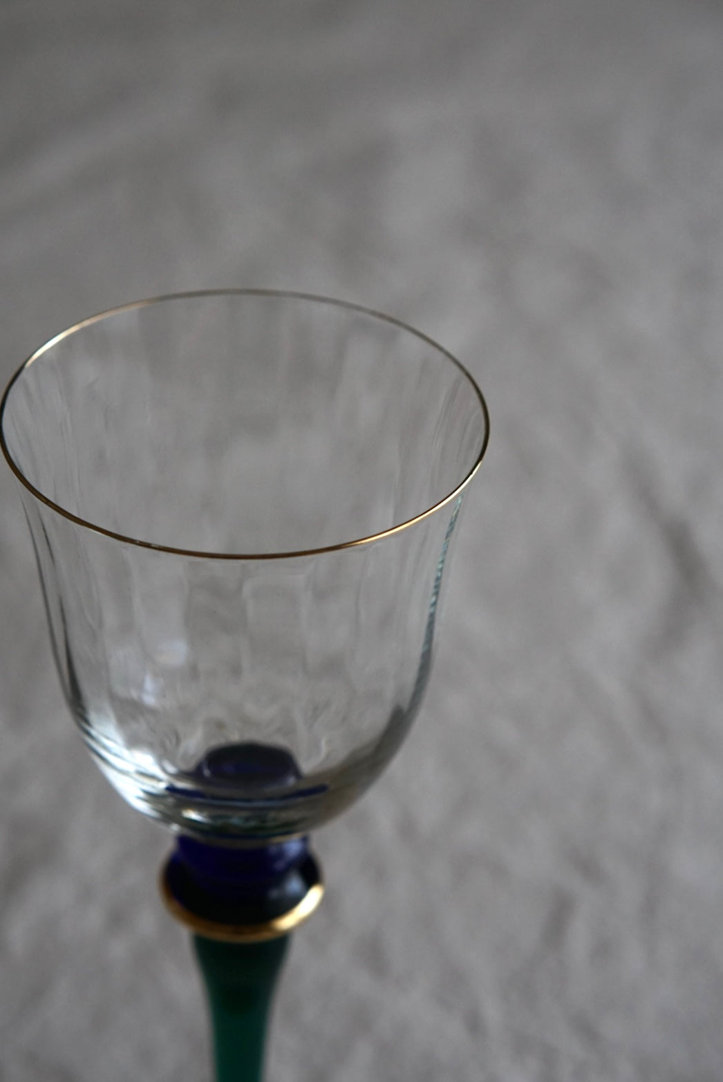 Blue-green used high-stemmed wine glass