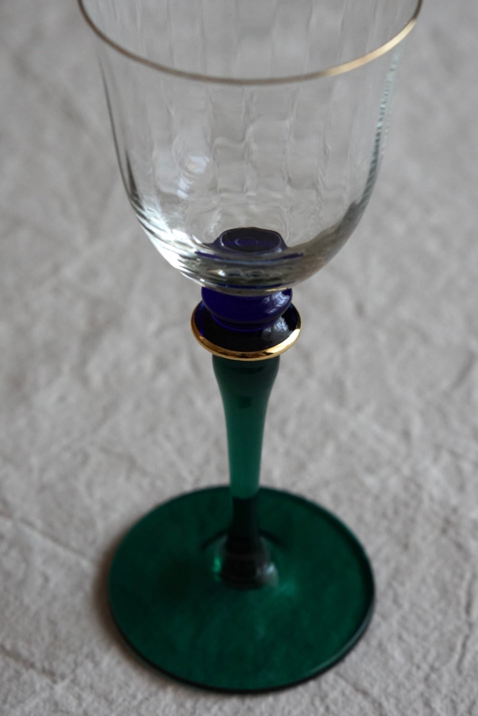 Blue-green used high-stemmed wine glass